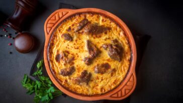 tave kosi e un piatto nazionale albanese di agnello al forno e riso con yogurt in una padella sul tavolo vista superiore orizzontale dall alto nome turco elbasan tava 693630 10691.jpg